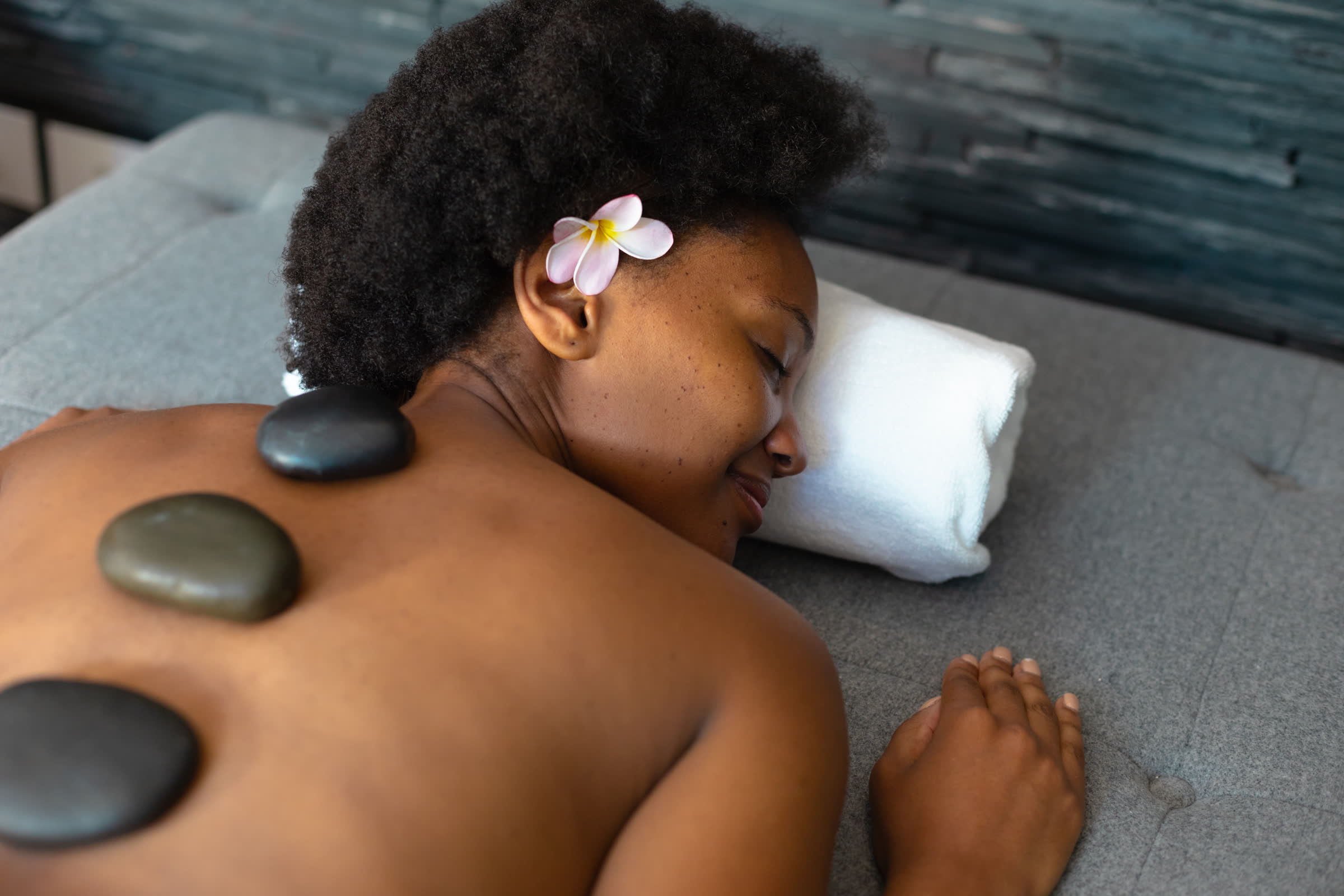 Woman relaxing during a hot stone massage